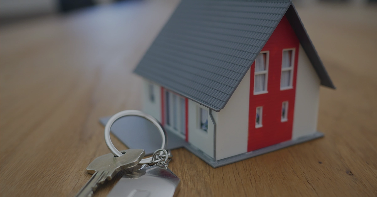 Photo of a toy house and a set of keys